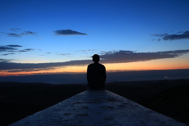 Living with Parkinson's Disease - photo of a man on a dock watching the sun rise